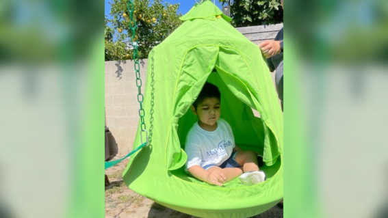 EJ relaxing under his play structure