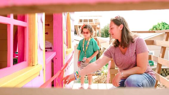 Penny walking up the steps of the finished playhouse with mom