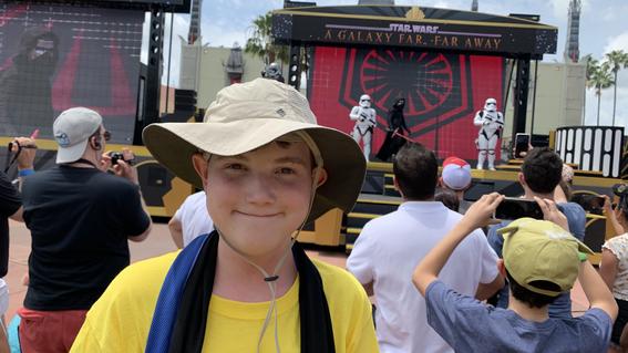 Edward posing in front of a Star Wars demonstration