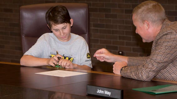 Westyn becoming junior CEO and makes it official with CEO John C. May.
