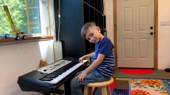 Uriah plays the piano in his Music House