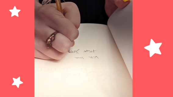 Mia signing her books