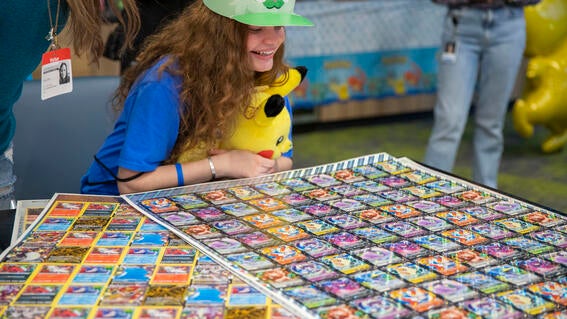 Selah smiling looking at pokemon cards