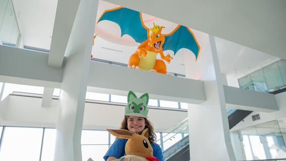 Selah in front of Charizard