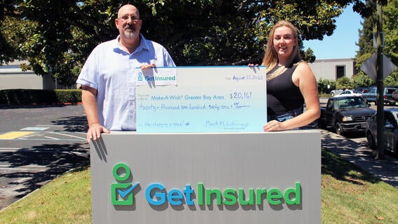 Mark McWhinney with big check and his daughter