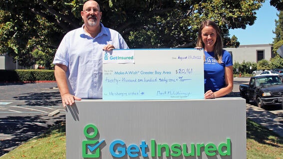 Mark McWhinney with big check and Allie Reynolds