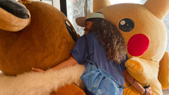 Selah hugging Evie and Pikachu