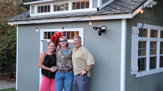Billy outside Shed with parents
