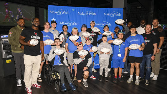 wish kids celebrating at dave & buster's with signed footballs
