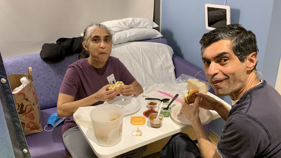Vivek's parents visiting Vivek in the hospital. 