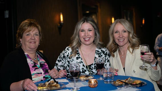 Three guests raise a glass and give cheers to 40 years