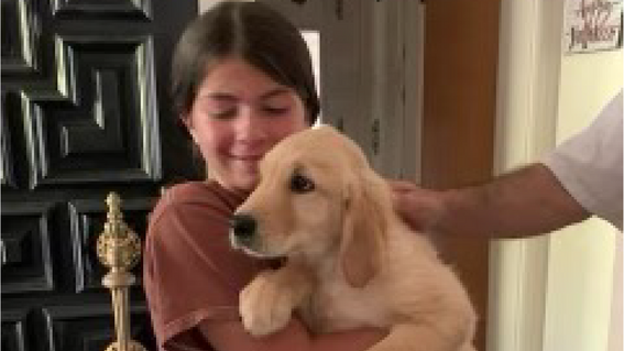 Bianca holds and hugs puppy