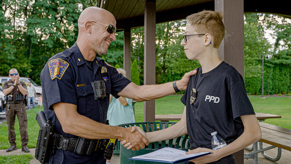 wish kid Johnny shaking hands with police officer