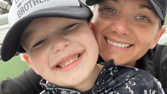 Brayden and his mom Alyssa smile while on Brayden's wish trip