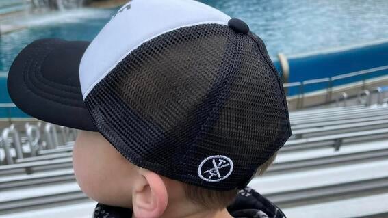 a photo from the back of Brayden as he watches an aquatic show during his wish.