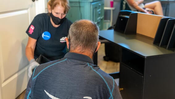 Amazon volunteers work together to assemble furniture