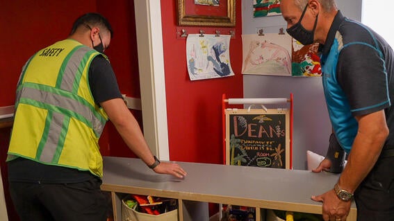 Amazon Wish Granter volunteers move furniture around Dean's room