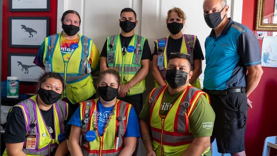 Amazon volunteers smile together just after finishing Dean's room
