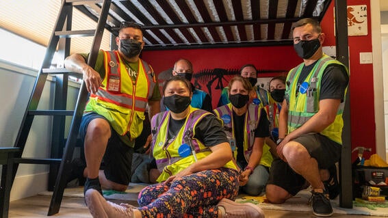 Amazon volunteers gathered under Dean's new bunk bed