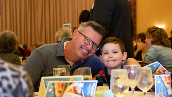Elliot with his dad at their table.