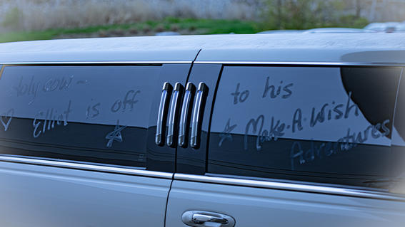 Elliot's limo window with messages wishing him well on his trip.