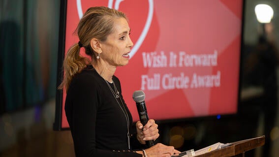 Volunteer and wish mom, Sue Proctor accepting the Wish It Forward Full Circle Award
