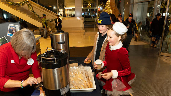 Stephanie serves hot chocolate to kids at the event. 
