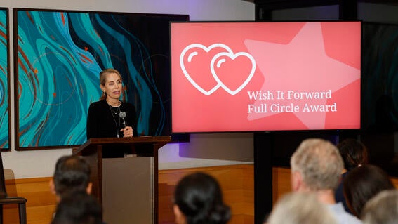 Sue Proctor accepting award at Wish Insiders Summit in 2023