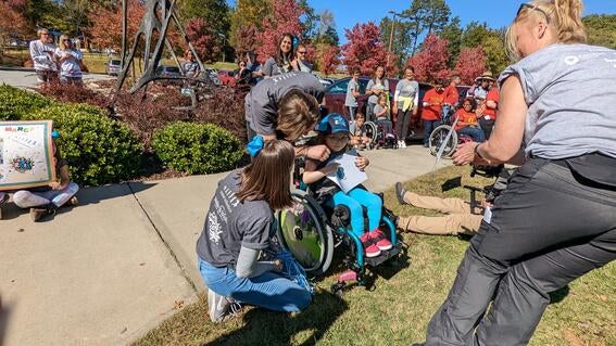 Marcy and her parents accepting an award during the Spina Bifida walk