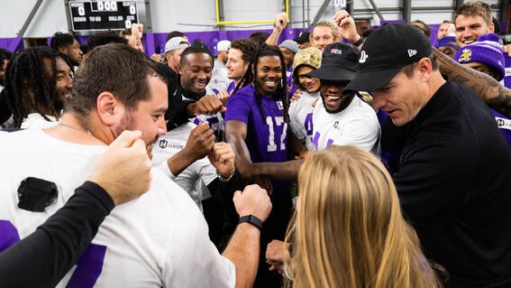 Sylvia joins in the Minnesota Viking's huddle.