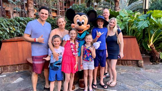 Alina with her family and Mickey Mouse