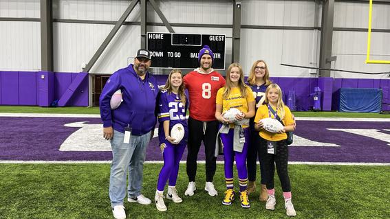 Sylvia and family pose with Kirk Cousins
