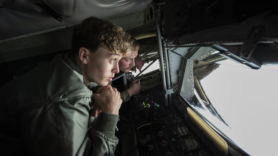Isaiah and pilot instructor looking through windshield from the inside of an airplane cockpit 