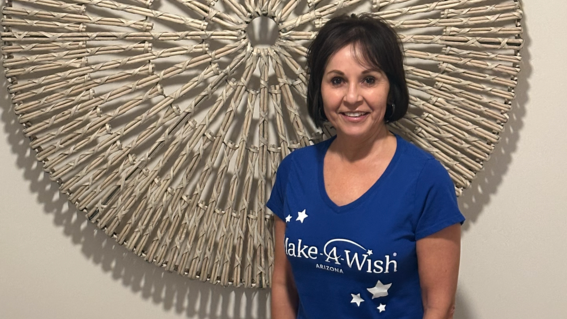Carolyn Chapparo stands proudly in her Make-A-Wish Arizona wish granter shirt. She has granted more than 150 wishes as a volunteer.