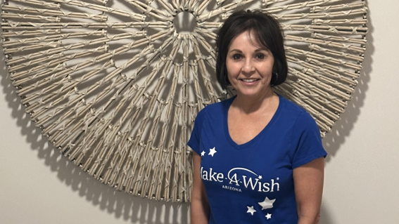 Carolyn Chapparo stands proudly in her Make-A-Wish Arizona wish granter shirt. She has granted more than 150 wishes as a volunteer.