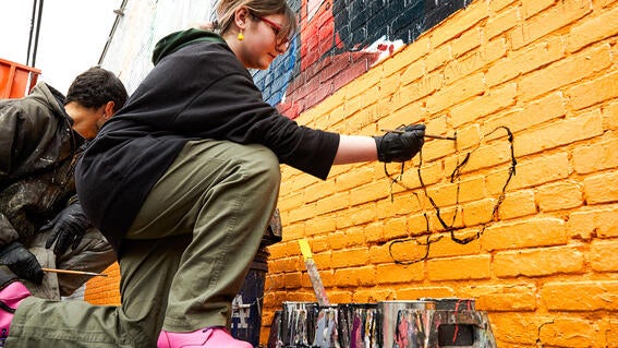 Wish Kid Josie signing mural