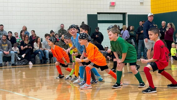 Students on the field rushing to get the dodgeball and make the first move.