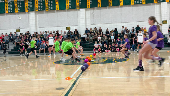 The game begins as students begin to throw their dodgeballs.