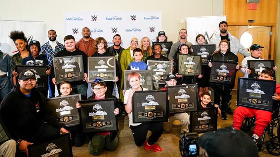 Wish kids presented with WWE plaques with WWE stars