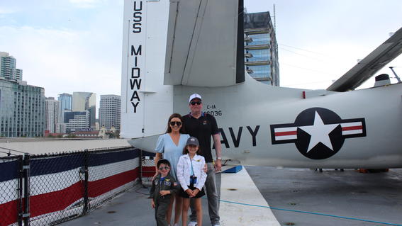 Hudson with family in front of plane