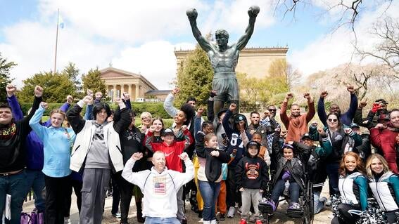 Wish kids and WWE stars in front of the Rocky statue in Philadelphia