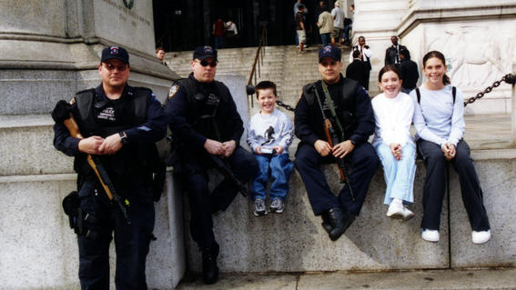 Matthew and his siblings with three NYPD officers