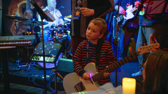 Nolan jamming out on the guitar during Nolan's wish to have a rock band experience.