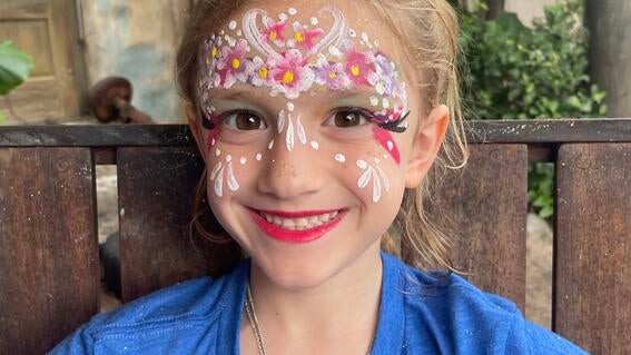 Zoe smiling with face makeup on