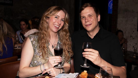A couple raises a glass to granting wishes. 