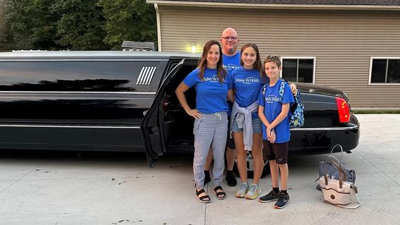 Ezra and his family standing in front of the limo
