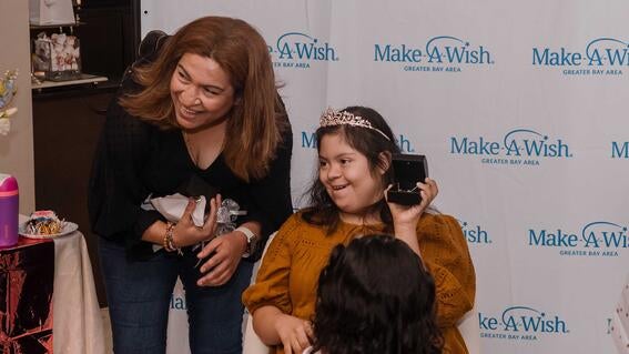 Lupita's with her mom Yolanda after opening her Padis Jewelry necklace.