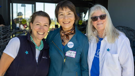 Make-A-Wish Greater Bay Area CEO Betsy Biern, wish mom Yang, and Chief Development Officer Kathleen Backus