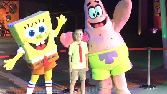 Waylon with the characters SpongeBob and Patrick at the Nickelodeon Resort in 2019.