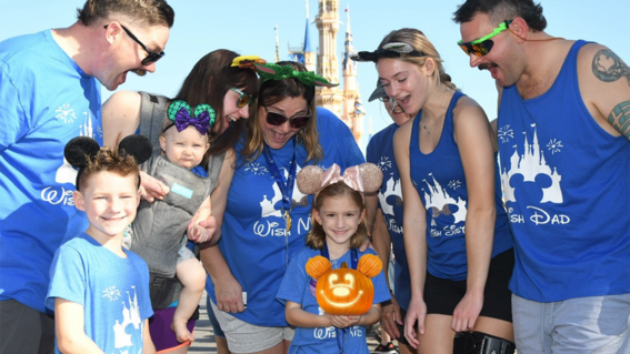 Zoe and her family. Zoe is holding a glowing carved pumpkin
